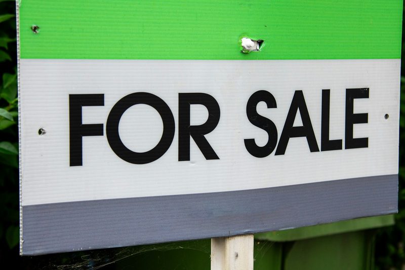 A For Sale sign in front of a home