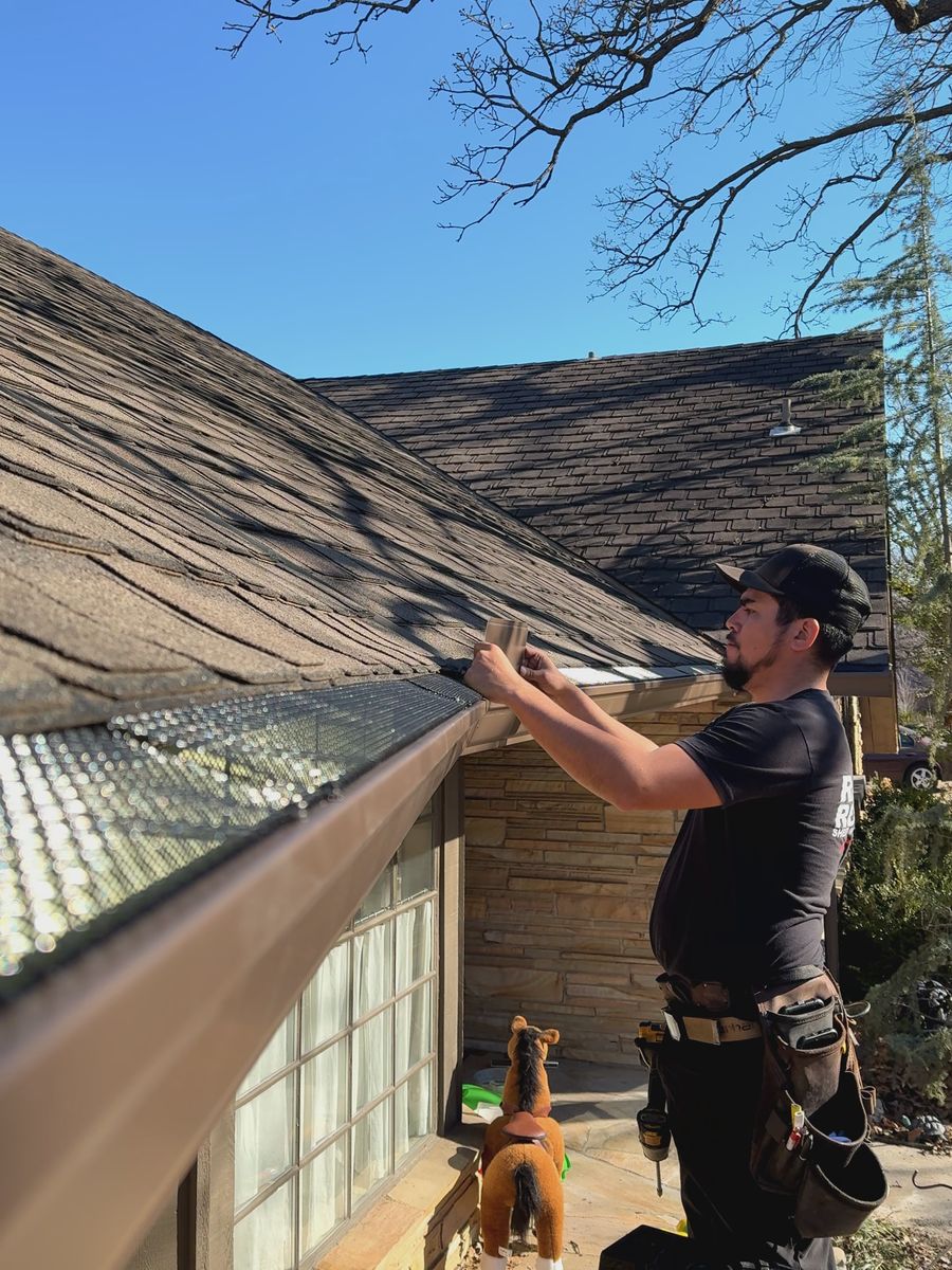 RainTech installer hanging a new seamless gutter on a home