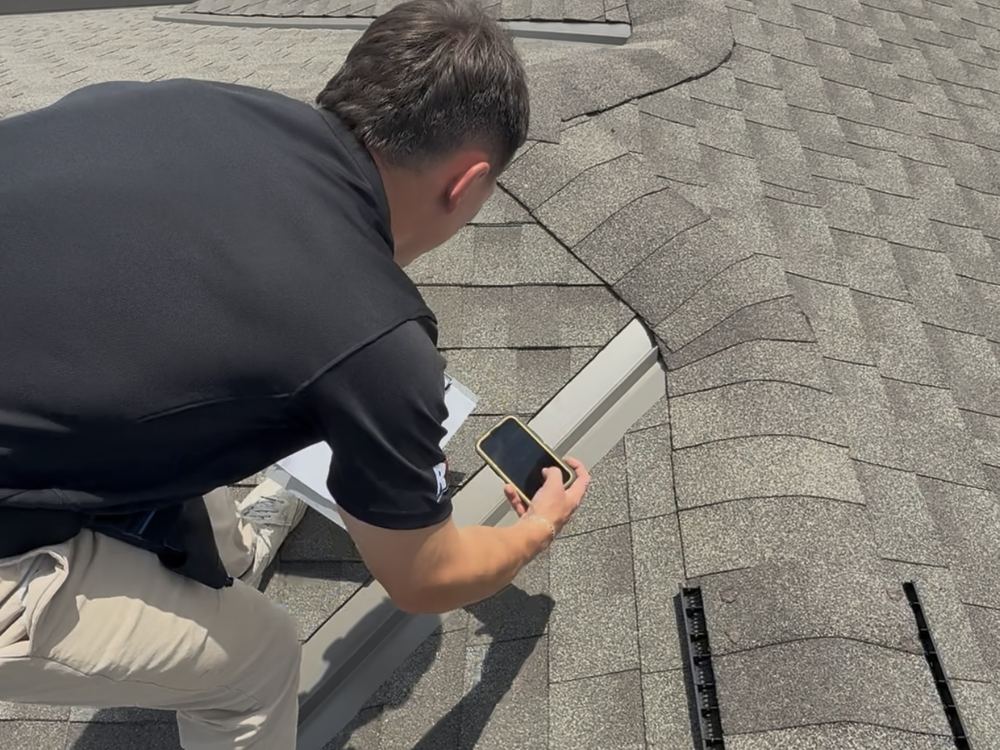 RainTech Roofing inspector photographing a roof