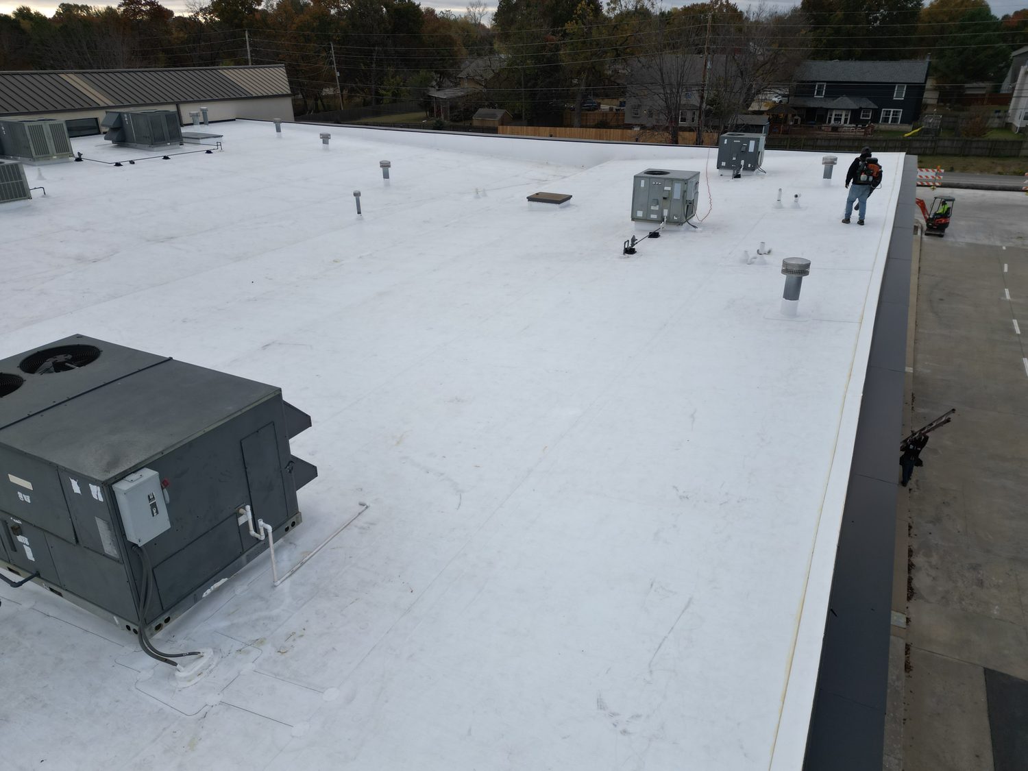 Crew finishing TPO around rooftop units