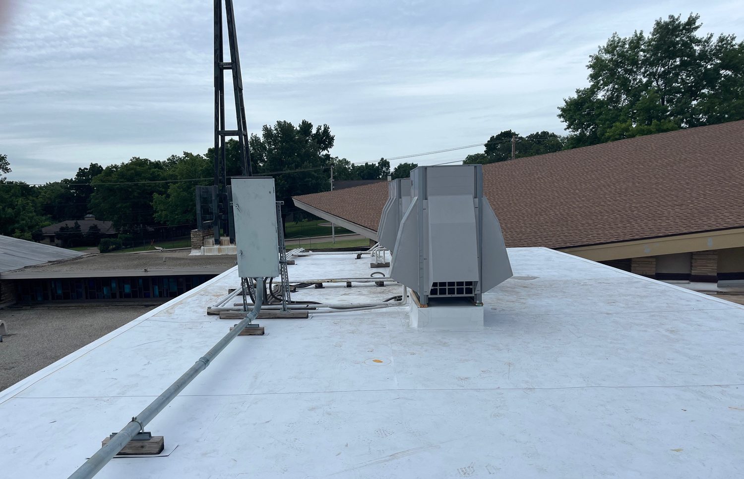 White TPO roof with rooftop equipment on a Tulsa-area church