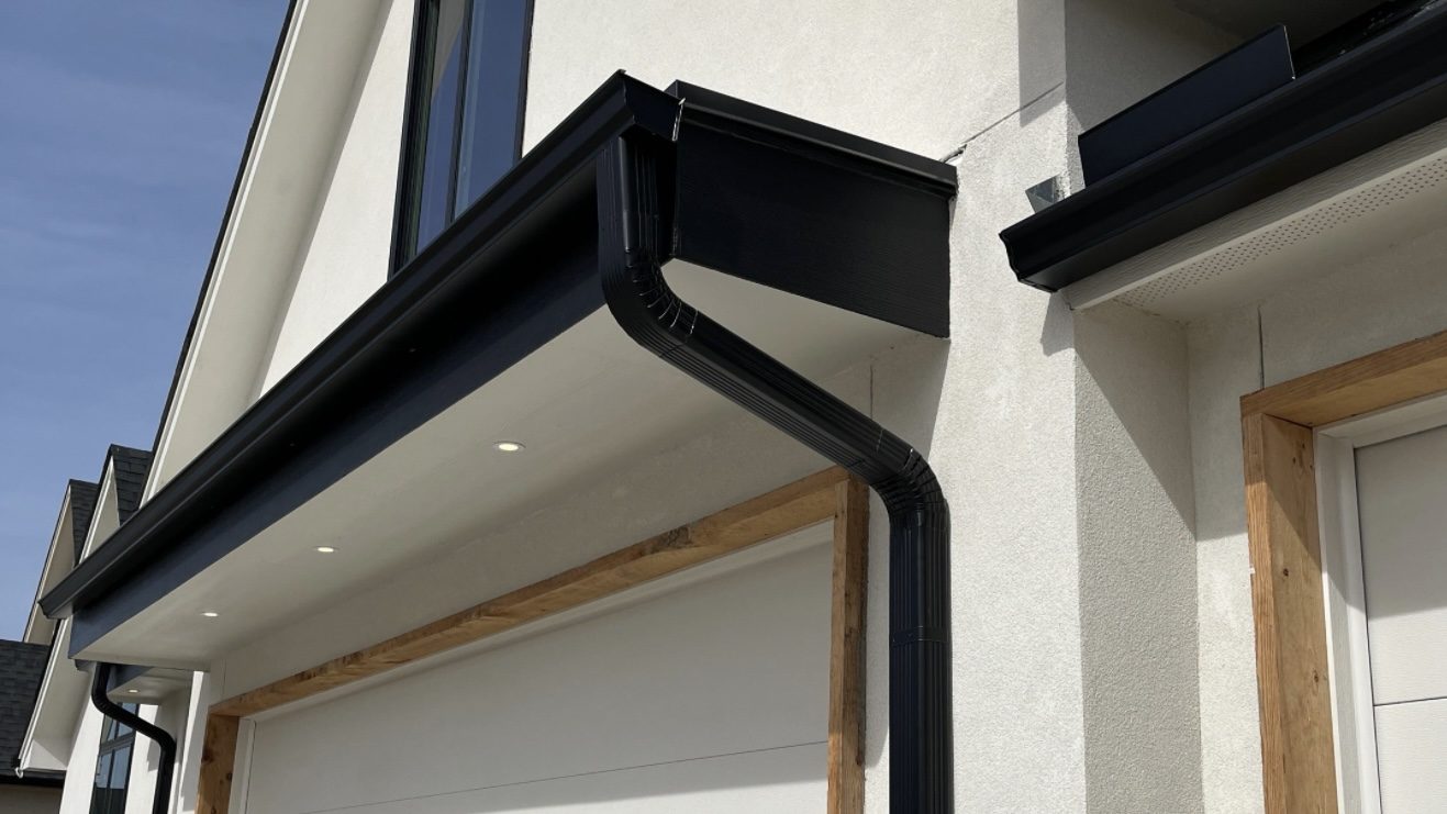 Black seamless aluminum gutter and downspout on a modern home