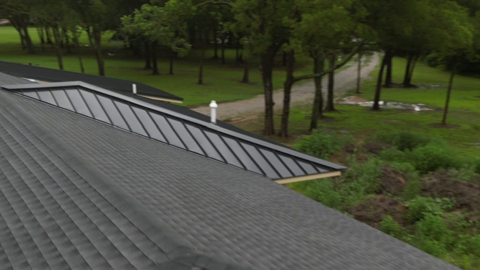 Standing seam porch roof beside shingles