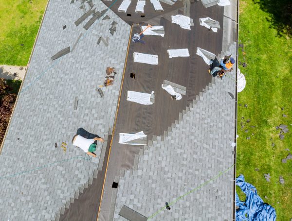 RainTech Roofing - Roofer working on replacement asphalt shingle roof