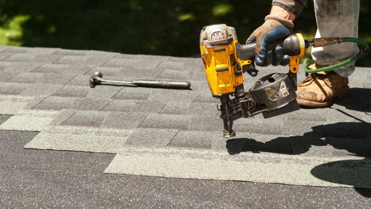 Roofer installing shingles