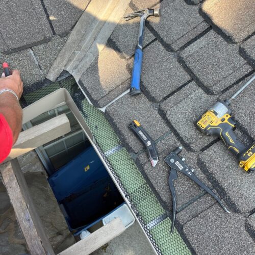 RainTech Roofing, Sheet Metal & Gutters installer adding new Tulsa seamless gutters to a home.