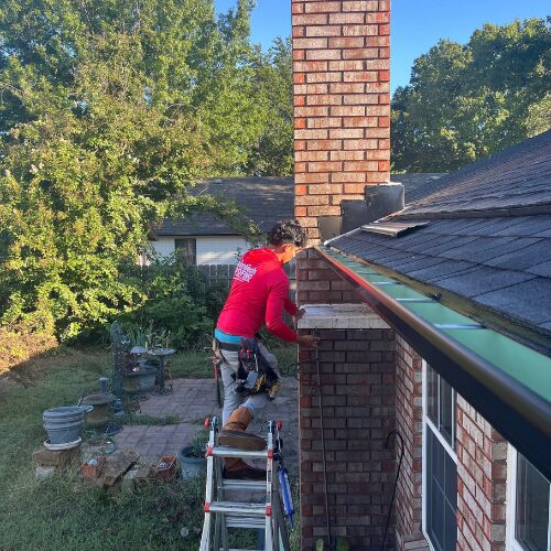 RainTech Roofing, Sheet Metal & Gutters installer adding new Tulsa seamless gutters to a home.