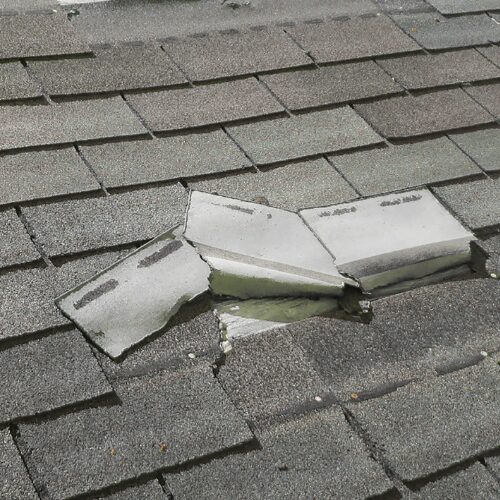 Wind Damaged Shingles on a residential roof